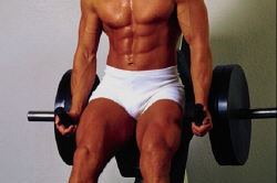 Muscled man sitting on weights.jpg