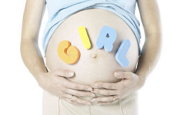 Pregnant woman with girl spelled out on stomach.jpg